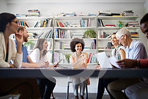 Cheerful coworkers in office during company meeting