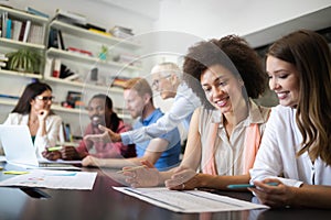 Cheerful coworkers in office during company meeting