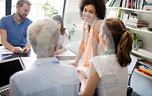 Cheerful coworkers in office during company meeting