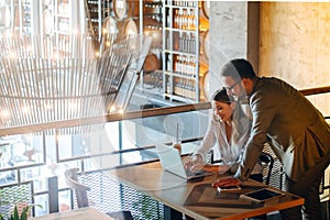 Cheerful coworkers in office working and brainstorming together