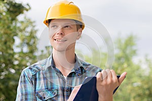 Cheerful craftsperson holding a clipboa