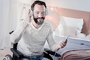 Cheerful crippled man listening to music