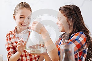 Cheerful curious girls conducting a research