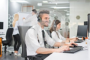 Cheerful customer service agents working in call center.
