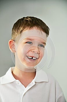 Cheerful cute boy portrait. the boy opened his mouth and lost a