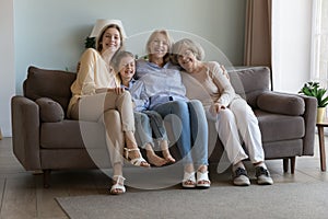 Cheerful cute girls and women of four family generations