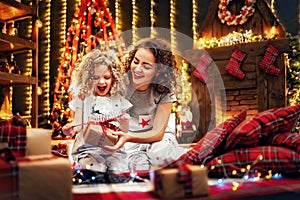 Cheerful cute little girl and her older sister exchanging gifts.