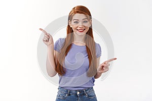 Cheerful, cute redhead caucasian female student in purple t-shirt sharing two choices, suggest variants, have few