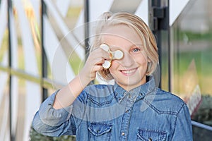 Cheerful cute school aged girl playing with a gold fidget spinner. A popular trendy toy.