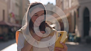 Cheerful deaf woman having video call on smartphone