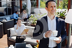 Cheerful delighted man being in a good mood