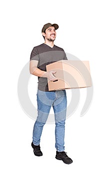Cheerful delivery man on the move, full length portrait, walking as carrying a cardboard parcel box to customer, isolated on white