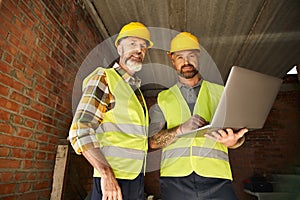 cheerful devoted construction workers in safety