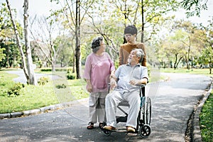 Cheerful disabled grandfather in wheelchair welcoming his happy