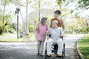 Cheerful disabled grandfather in wheelchair welcoming his happy