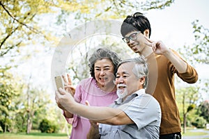 Cheerful disabled grandfather in wheelchair welcoming his happy