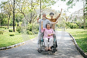 Cheerful disabled grandfather in wheelchair welcoming his happy