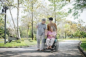 Cheerful disabled grandfather in wheelchair welcoming his happy