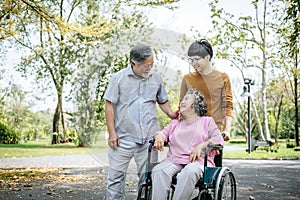 Cheerful disabled grandfather in wheelchair welcoming his happy