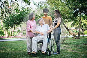 Cheerful disabled grandfather in wheelchair welcoming his happy