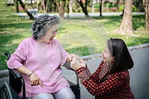 Cheerful disabled grandfather in wheelchair welcoming his happy