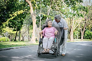 Cheerful disabled grandfather in wheelchair welcoming his happy