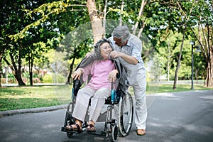 Cheerful disabled grandfather in wheelchair welcoming his happy