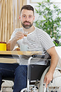 cheerful disabled man drinking tea