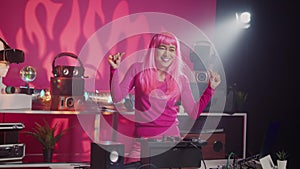 Cheerful dj performing electronic music during concert