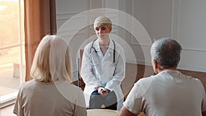 Cheerful Doctor Lady Consulting Senior Couple During Appointment Indoor