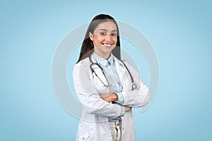 Cheerful doctor with stethoscope posing confidently