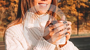 Cheerful drinking coffee. Happy young girl with cup of tea in sunshine light enjoying her morning coffee. Beautiful woman