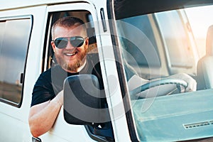 Cheerful driver in sunglasses