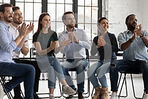 Cheerful employees clap hands encourage business coach start workshop photo