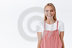 Cheerful, enthusiastic caucasian blond woman in casual outfit give customers sincere friendly smile to brighten up day