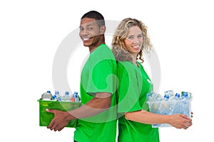 Cheerful environmental activists holding box of recyclables and