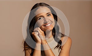 Cheerful european senior woman with perfect skin, enjoy anti-wrinkle treatment