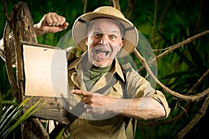 Cheerful explorer pointing to a sign