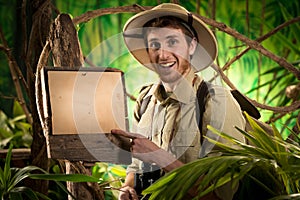 Cheerful explorer with sign