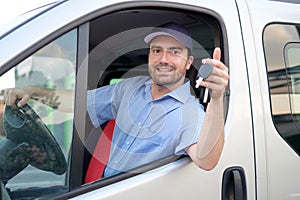 Cheerful express courier inside his van