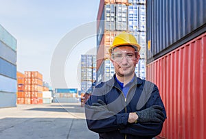 Cheerful factory worker man in hard hat smiling with arms crossed as sign of Success