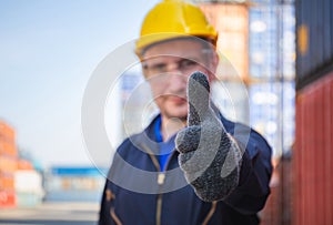 Cheerful factory worker man smiling with giving thumbs up as sign of Success