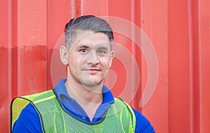 Cheerful factory worker man smiling and looking at camera with joy, Happiness concept