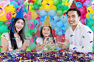 Cheerful family celebrating birthday party