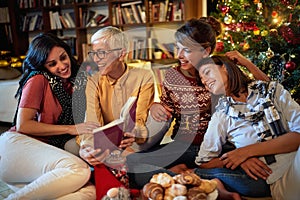 Cheerful family for Christmas in front of a decorated x-mas tree. mather and her daughter together at holiday