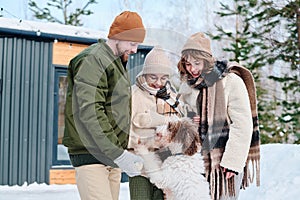 Cheerful Family With Dog Outdoors On Winter Day