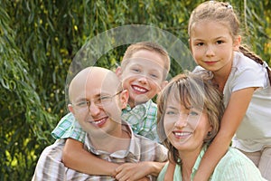 Cheerful family in early fall park