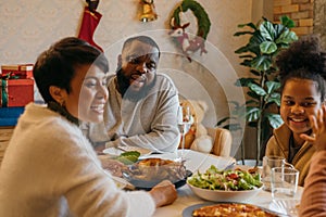 Cheerful family enjoying christmas lunch at home
