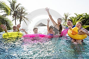 Cheerful family enjoying the summertime in a pool