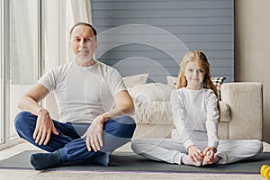 Cheerful family exercising together in house